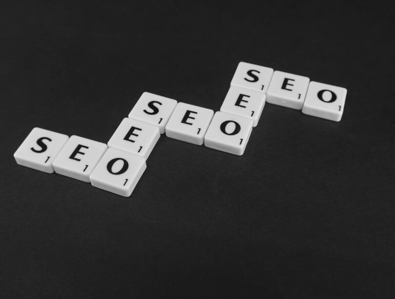 Checker letters spelling SEO. Bilingual SEO